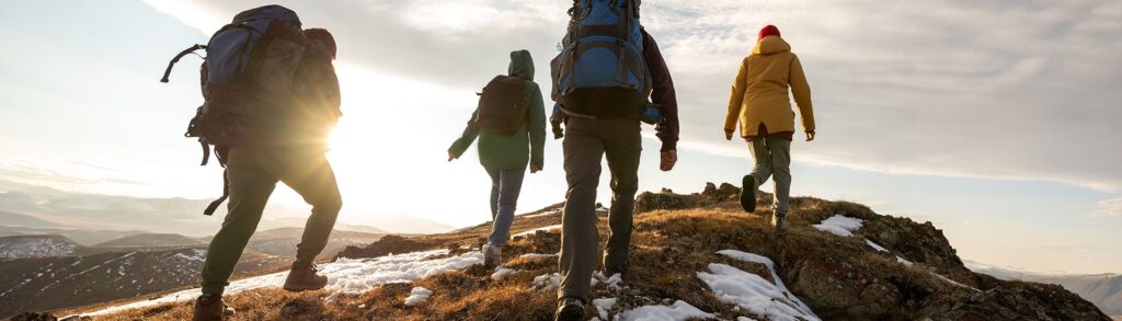 Photograph of people hiking on a hill